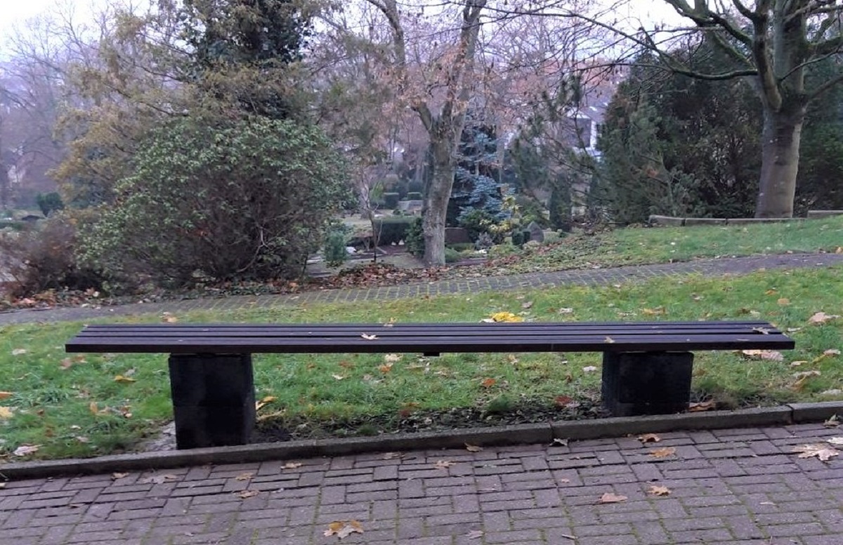 Foto einer Bank an einem schrägen Weg. Dadurch entstehen unterschiedliche Sitzhöhen.